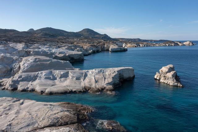 This aerial picture taken on February 3, 2026, shows Sarakiniko Beach in the Greek Aegean island of Milos. On the sloping coastline facing the Aegean Sea, the vast construction site looks like a gaping wound inflicted on the volcanic rock. ‘An ecological crime’ according to Manolis Mikelis, mayor of Milos, the Greek island in the Cyclades where this luxury hotel has begun extensive expansion work. "The geological uniqueness of Milos is known throughout the world. We don't want its identity to change," grumbles the mayor. Private villas and high-end complexes: the entire archipelago, known for its whitewashed houses and blue church domes, is caught up in a real estate fever fuelled by the tourism boom. (Photo by Aris MESSINIS / AFP)