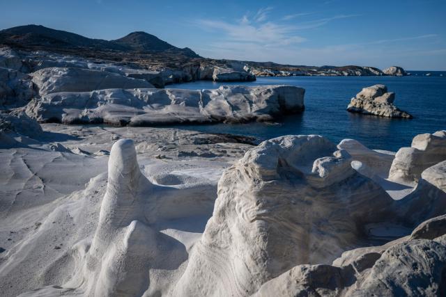 This picture taken on February 3, 2026, shows Sarakiniko Beach in the Greek Aegean island of Milos. On the sloping coastline facing the Aegean Sea, the vast construction site looks like a gaping wound inflicted on the volcanic rock. ‘An ecological crime’ according to Manolis Mikelis, mayor of Milos, the Greek island in the Cyclades where this luxury hotel has begun extensive expansion work. "The geological uniqueness of Milos is known throughout the world. We don't want its identity to change," grumbles the mayor. Private villas and high-end complexes: the entire archipelago, known for its whitewashed houses and blue church domes, is caught up in a real estate fever fuelled by the tourism boom. (Photo by Aris MESSINIS / AFP)