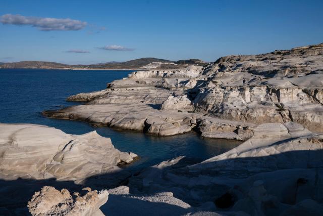 This picture taken on February 3, 2026, shows Sarakiniko Beach in the Greek Aegean island of Milos. On the sloping coastline facing the Aegean Sea, the vast construction site looks like a gaping wound inflicted on the volcanic rock. ‘An ecological crime’ according to Manolis Mikelis, mayor of Milos, the Greek island in the Cyclades where this luxury hotel has begun extensive expansion work. "The geological uniqueness of Milos is known throughout the world. We don't want its identity to change," grumbles the mayor. Private villas and high-end complexes: the entire archipelago, known for its whitewashed houses and blue church domes, is caught up in a real estate fever fuelled by the tourism boom. (Photo by Aris MESSINIS / AFP)
