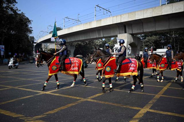 Police personnel patrol on horses along a street during Bangladesh's general election in Dhaka on February 12, 2026. (Photo by Sajjad HUSSAIN / AFP)