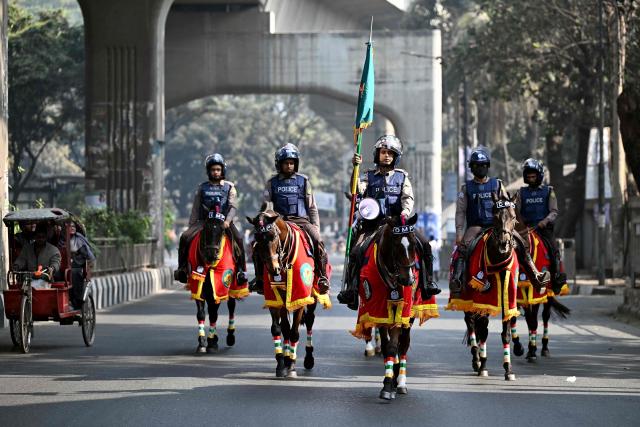 Police personnel patrol on horses along a street during Bangladesh's general election in Dhaka on February 12, 2026. (Photo by Sajjad HUSSAIN / AFP)