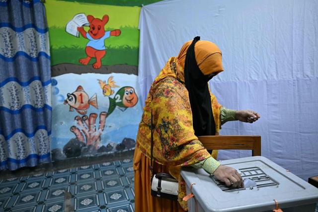 A woman casts her ballot at a polling station during Bangladesh's general election in Dhaka on February 12, 2026. (Photo by Sajjad HUSSAIN / AFP)