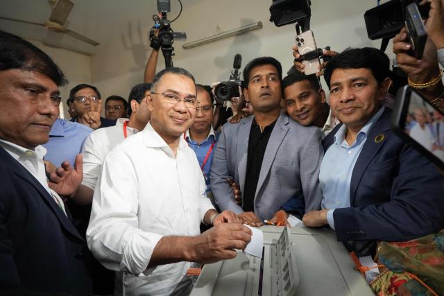 Bangladesh Nationalist Party (BNP) chairman and election candidate Tarique Rahman (C) casts his ballot at a polling station during Bangladesh's general election in Dhaka on February 12, 2026. (Photo by Monzur Morsed RICKY / AFP)