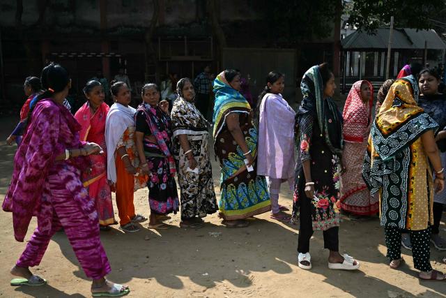 Bangladeshi Hindu women wait to cast their ballot at a polling station during Bangladesh's general election in Dhaka on February 12, 2026. (Photo by Sajjad HUSSAIN / AFP)