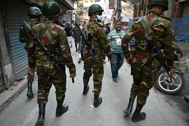 Bangladesh Army personnel patrol along a street outside a polling station during Bangladesh's general election in Dhaka on February 12, 2026. (Photo by MOHD RASFAN / AFP)