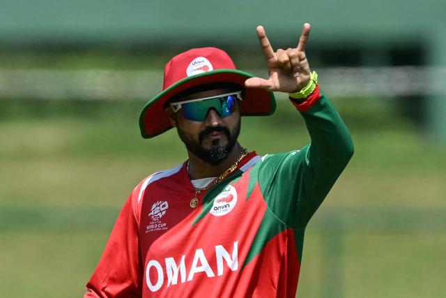 Oman's captain Jatinder Singh gestures during the toss before the start of the 2026 ICC Men's T20 Cricket World Cup group stage match between Sri Lanka and Oman at the Pallekele International Cricket Stadium in Kandy on February 12, 2026. (Photo by Ishara S. KODIKARA / AFP)