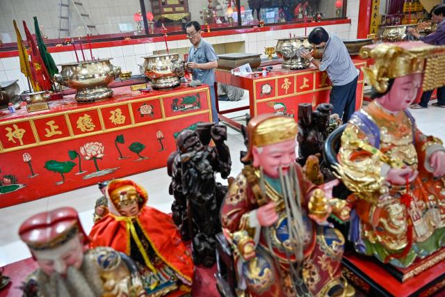 Volunteers clean the Dharma Bakti Temple in Banda Aceh, Indonesia's Aceh province on February 12, 2026, in preparation for the upcoming Lunar New Year of the Horse. (Photo by CHAIDEER MAHYUDDIN / AFP)