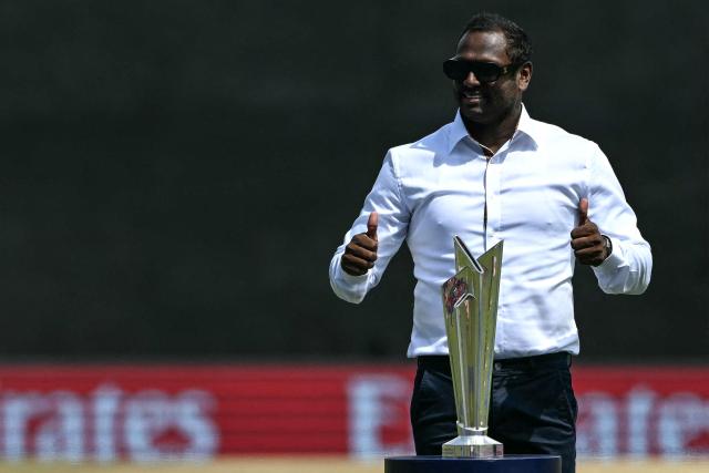 Former Sri Lankan cricketer Angelo Mathews poses with the 2026 ICC Men's T20 Cricket World Cup trophy before the start of the group stage match between Sri Lanka and Oman at the Pallekele International Cricket Stadium in Kandy on February 12, 2026. (Photo by Ishara S. KODIKARA / AFP)