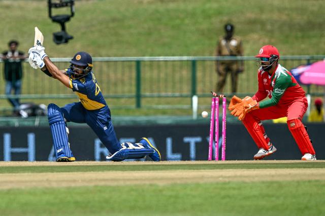 Sri Lanka's Kamil Mishara (L) is clean bowled by Oman's Jay Odedra during the 2026 ICC Men's T20 Cricket World Cup group stage match between Sri Lanka and Oman at the Pallekele International Cricket Stadium in Kandy on February 12, 2026. (Photo by Ishara S. KODIKARA / AFP)
