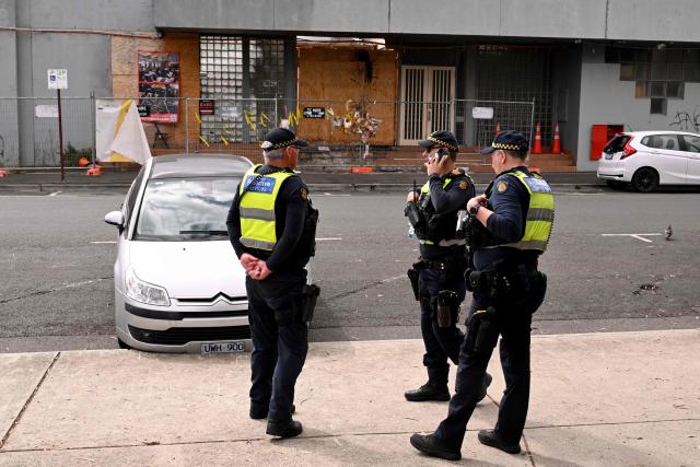 Protective service officers stand outside the torched Adass Israel Synagogue in Melbourne on February 12, 2026. Israel’s President Isaac Herzog was scheduled to visit the synagogue during his visit to Melbourne, but the event was cancelled. Herzog's tightly secured, four-day trip aims to console Australia's Jewish community after the December shooting at Sydney's Bondi Beach that killed 15 people at a Hanukkah festival. (Photo by WILLIAM WEST / AFP)
