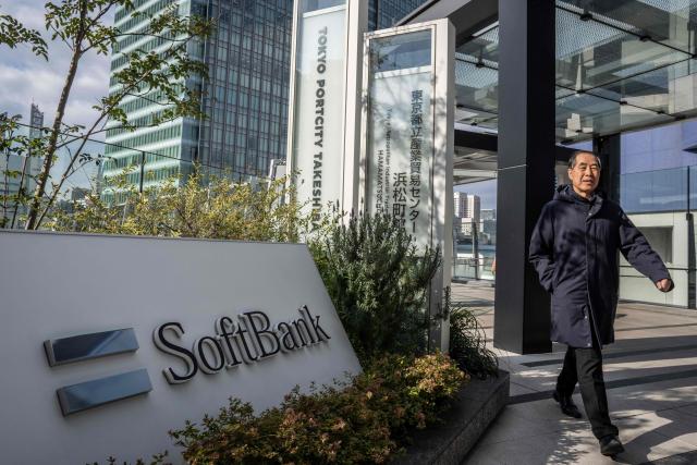 A man walks outside the headquarters of Japanese company SoftBank Group in Tokyo on February 12, 2026. (Photo by Yuichi YAMAZAKI / AFP)