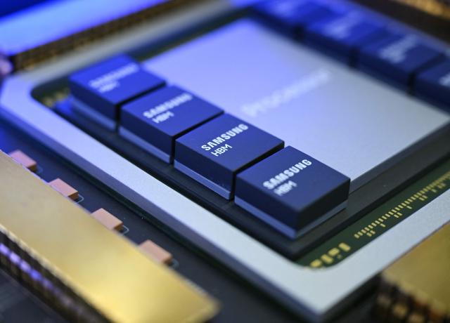 This picture taken on October 22, 2025 shows a mockup of a chipset featuring Samsung Electronics' high-bandwidth memory (HBM) technology on display during the 2025 Semiconductor Exhibition in Seoul. South Korean tech giant Samsung Electronics said on February 12, 2026 it has started mass production of a next-generation memory chip to power artificial intelligence. (Photo by Jung Yeon-je / AFP)