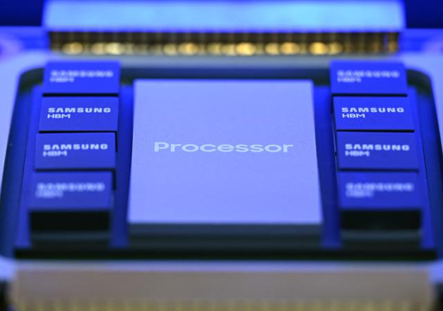 This picture taken on October 22, 2025 shows a mockup of a chipset featuring Samsung Electronics' high-bandwidth memory (HBM) technology on display during the 2025 Semiconductor Exhibition in Seoul. South Korean tech giant Samsung Electronics said on February 12, 2026 it has started mass production of a next-generation memory chip to power artificial intelligence. (Photo by Jung Yeon-je / AFP)