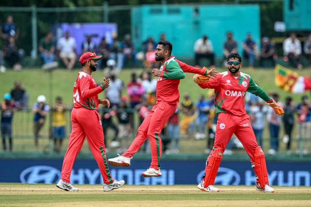 Oman's players celebrate after the dismissal of Sri Lanka's Kusal Mendis during the 2026 ICC Men's T20 Cricket World Cup group stage match between Sri Lanka and Oman at the Pallekele International Cricket Stadium in Kandy on February 12, 2026. (Photo by Ishara S. KODIKARA / AFP)