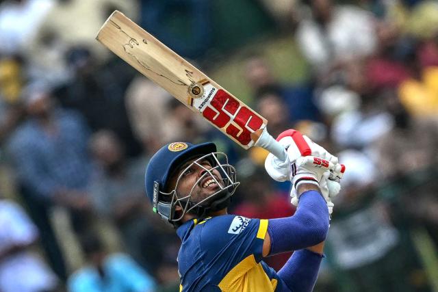 Sri Lanka's captain Dasun Shanaka watches the ball after playing a shot during the 2026 ICC Men's T20 Cricket World Cup group stage match between Sri Lanka and Oman at the Pallekele International Cricket Stadium in Kandy on February 12, 2026. (Photo by Ishara S. KODIKARA / AFP)