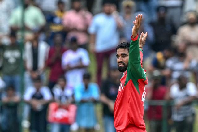 Oman's Jiten Ramanandi celebrates after taking the wicket of Sri Lanka's captain Dasun Shanaka during the 2026 ICC Men's T20 Cricket World Cup group stage match between Sri Lanka and Oman at the Pallekele International Cricket Stadium in Kandy on February 12, 2026. (Photo by Ishara S. KODIKARA / AFP)