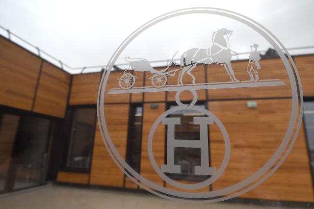 (FILES) The new Hermes (La Manufacture de l'Allan Hermès) logo is pictured in the new leather goods workshop of French high fashion luxury goods manufacturer Hermes (La Manufacture de l'Allan Hermès), on the eve of its inauguration day, on April 5, 2018 in Allenjoie, northeastern France. The luxury group Hermès announced on February 12, 2026 a 1.72% drop in its 2025 net profit, to 4.5 billion euros, driven in particular by the exceptional surtax imposed on large companies in the name of restoring Frances public finances. (Photo by SEBASTIEN BOZON / AFP)