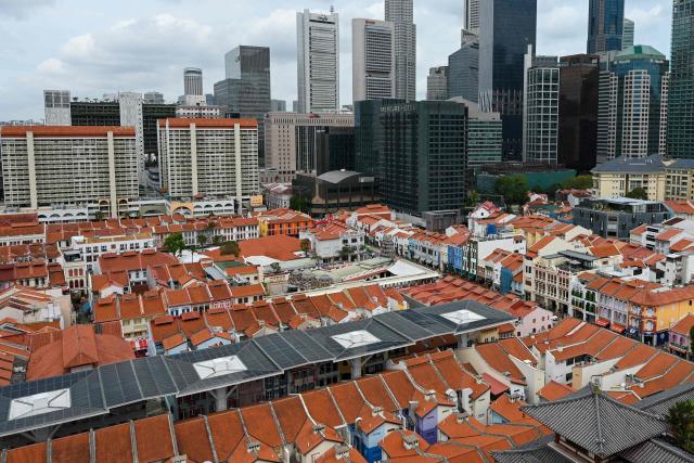 A general view shows low-rise buildings next to the commercial buildings of the Central Business District in Singapore on February 12, 2026. (Photo by Roslan RAHMAN / AFP)