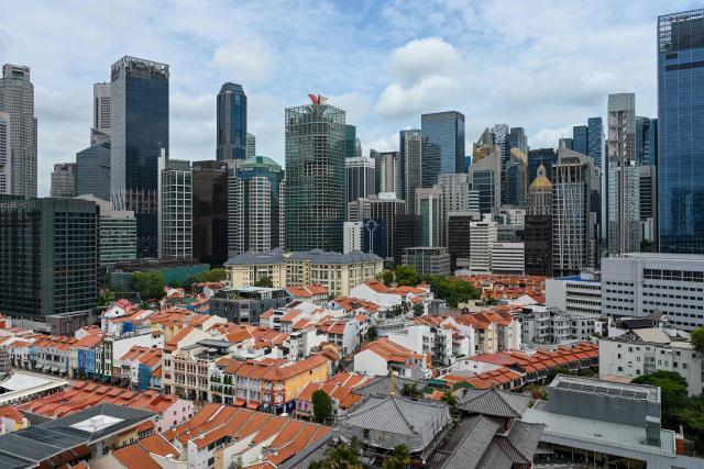 A general view shows low-rise buildings next to the commercial buildings of the Central Business District in Singapore on February 12, 2026. (Photo by Roslan RAHMAN / AFP)