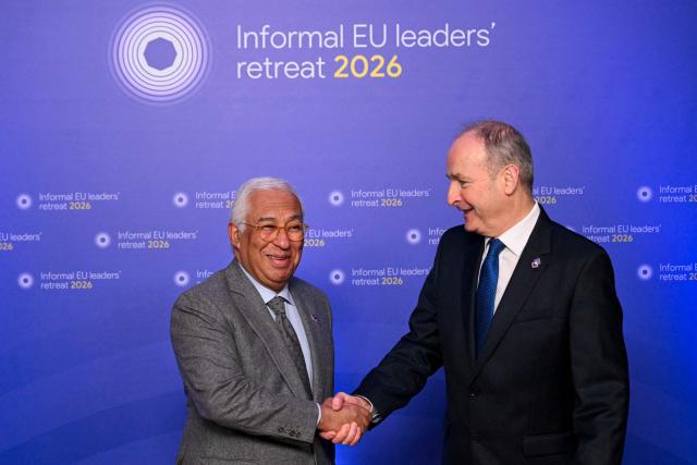 European Council President Antonio Costa (L) shakes hands with Ireland's Prime Minister Micheal Martin as he welcomes European leaders during the Informal EU Leaders Retreat at the Alden Biesen Castle, central Belgium on February 12, 2026. (Photo by NICOLAS TUCAT / AFP)