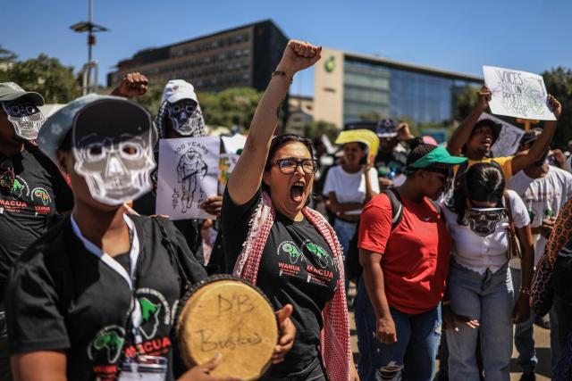 Members of South Africa's mining affected communities react during their protest outside Anglo American's headquarters in Johannesburg on February 12, 2026. Protesters are demanding full accountability before Anglo American exits South Africa, including rehabilitation, outstanding social obligations and transparency on liabilities. (Photo by Phill Magakoe / AFP)