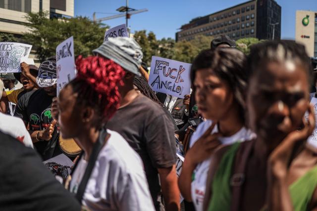 Members of South Africa's mining affected communities react during their protest outside Anglo American's headquarters in Johannesburg on February 12, 2026. Protesters are demanding full accountability before Anglo American exits South Africa, including rehabilitation, outstanding social obligations and transparency on liabilities. (Photo by Phill Magakoe / AFP)