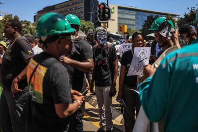 Members of South Africa's mining affected communities react during their protest outside Anglo American's headquarters in Johannesburg on February 12, 2026. Protesters are demanding full accountability before Anglo American exits South Africa, including rehabilitation, outstanding social obligations and transparency on liabilities. (Photo by Phill Magakoe / AFP)