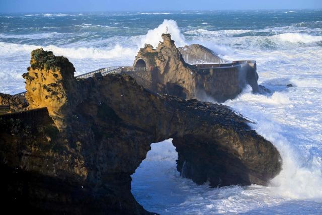 Waves crash at the Rock of the Virgin (Rocher de la Vierge) in Biarritz, southwestern France on February 12, 2026, as storm Nils hits the area. Accompanied by winds exceeding 160 km/h, Storm Nils swept across several regions of France on February 12, 2026, causing the death of a lorry driver in the Landes and damage, leaving 850,000 homes without electricity, particularly in the southwest. (Photo by Gaizka IROZ / AFP)