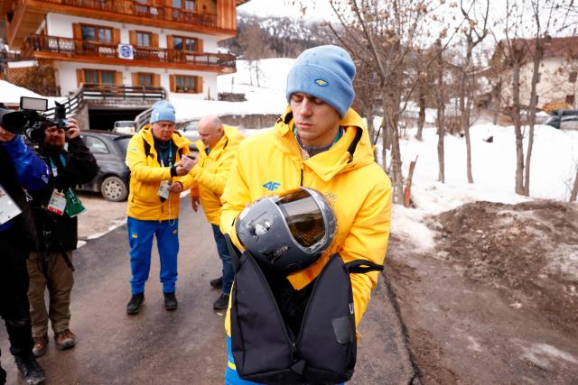 Ukraine's skeleton racer Vladyslav Heraskevych holds his helmet, which depicts victims of his country's war with Russia, in Cortina d'Ampezzo on February 12, 2026. Heraskevych was disqualified from the Winter Olympics on February 12, 2026 after refusing to back down over his banned helmet, which depicts victims of his country's war with Russia.
The International Olympic Committee said he had been kicked out of the Milan-Cortina Games "after refusing to adhere to the IOC athlete expression guidelines". (Photo by Odd ANDERSEN / AFP)
