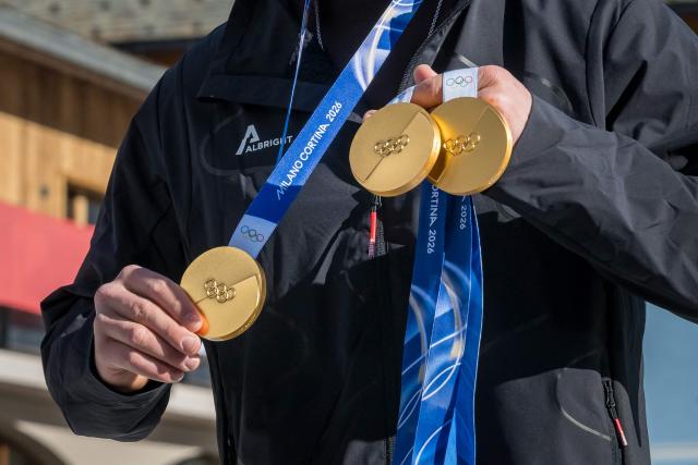 CORRECTION / Switzerland's Franjo von Allmen holds up his three gold medals for the men's alpine skiing downhill, super-G and team combined events as he poses during the Milano Cortina 2026 Winter Olympic Games at the Stelvio Ski Centre in Bormio (Valtellina) on February 12, 2026. (Photo by Fabrice COFFRINI / AFP) / The erroneous mention appearing in the metadata of this photo by Fabrice COFFRINI has been modified in AFP systems in the following manner: [on February 12] instead of [on February 11]. Please immediately remove the erroneous mention from all your online services and delete it from your servers. If you have been authorized by AFP to distribute it to third parties, please ensure that the same actions are carried out by them. Failure to promptly comply with these instructions will entail liability on your part for any continued or post notification usage. Therefore we thank you very much for all your attention and prompt action. We are sorry for the inconvenience this notification may cause and remain at your disposal for any further information you may require.