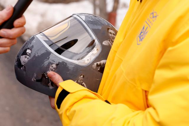 Ukraine's skeleton racer Vladyslav Heraskevych holds his helmet, which depicts victims of his country's war with Russia, in Cortina d'Ampezzo on February 12, 2026. Heraskevych was disqualified from the Winter Olympics on February 12, 2026 after refusing to back down over his banned helmet, which depicts victims of his country's war with Russia.
The International Olympic Committee said he had been kicked out of the Milan-Cortina Games "after refusing to adhere to the IOC athlete expression guidelines". (Photo by Odd ANDERSEN / AFP)