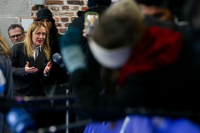 Italy's Prime Minister Giorgia Meloni (L) addresses the media as she arrives to take part in the Informal EU Leaders' Retreat at the Alden Biesen Castle in Alden Biesen, central Belgium on February 12, 2026. (Photo by NICOLAS TUCAT / AFP)
