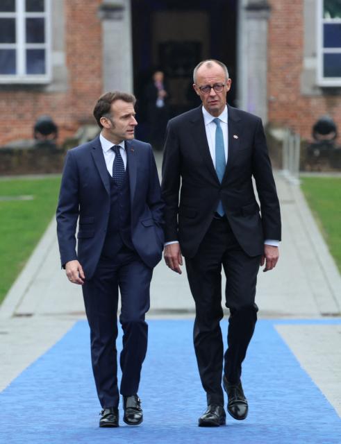 France's President Emmanuel Macron (L) and Germany's Chancellor Friedrich Merz arrive to attend the Informal EU Leaders' Retreat at the Alden Biesen Castle in Alden Biesen, central Belgium on February 12, 2026. (Photo by Ludovic MARIN / AFP)