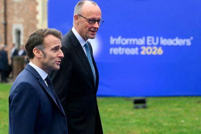 France's President Emmanuel Macron (L) and Germany's Chancellor Friedrich Merz arrive to attend the Informal EU Leaders' Retreat at the Alden Biesen Castle in Alden Biesen, central Belgium on February 12, 2026. (Photo by NICOLAS TUCAT / AFP)