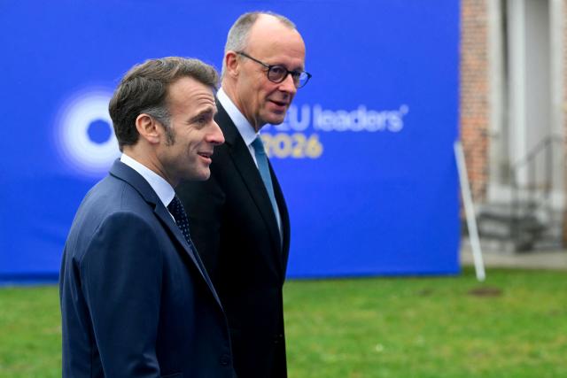 France's President Emmanuel Macron (L) and Germany's Chancellor Friedrich Merz arrive to attend the Informal EU Leaders' Retreat at the Alden Biesen Castle in Alden Biesen, central Belgium on February 12, 2026. (Photo by NICOLAS TUCAT / AFP)