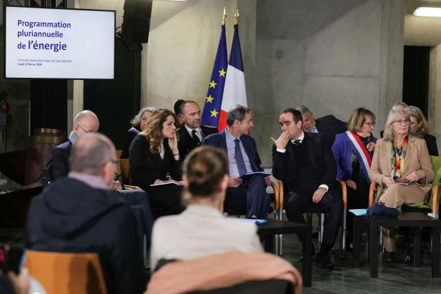 Electricite de France (EDF) CEO Bernard Fontana (C-L) listens to France's Prime Minister Sebastien Lecornu (C) while attending a roundtable at the hydroelectric power plant in Saut-Mortier, eastern France on February 12, 2026. What new energy policy for France in 2035? French government approved on February 12, 2026 a stagnation in electricity consumption, which is leading it to slow down the deployment of onshore wind and solar energy, alongside a massive revival of nuclear power. (Photo by Thomas SAMSON / AFP)