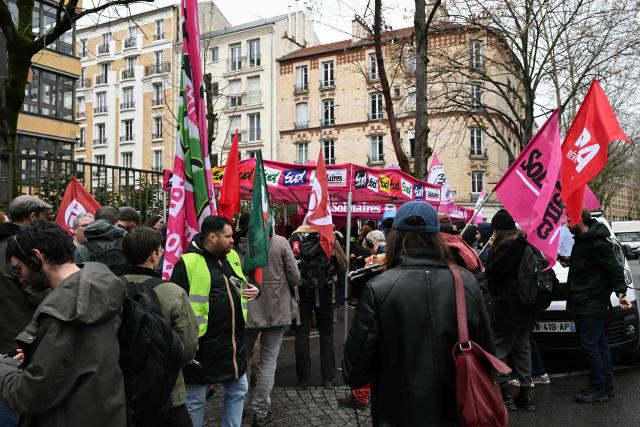 Protestors attend a gathering organised by union Solidaires in front of Amazon headquarters in Clichy, suburbs of Paris on February 12, 2026 to denounce sanctions, pressures towards employees. (Photo by Bertrand GUAY / AFP)