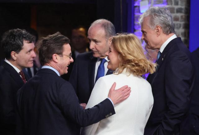 (From L) Romania's President Nicusor Dan (L), Ireland's Prime Minister Micheal Martin (C) speak with Lithuania's President Gitanas Nauseda (R) and Bulgaria's Prime Minister Rosen Zhelyazkov (2nd R) as they attend the Informal EU Leaders' Retreat at the Alden Biesen Castle in Alden Biesen, central Belgium on February 12, 2026. (Photo by Ludovic MARIN / AFP)