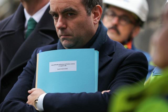 France's Prime Minister Sebastien Lecornu listens to explanations while attending a visit at the barrage de Vouglans (an hydroelectric dam), in Vouglans, eastern France on February 12, 2026. What new energy policy for France in 2035? French government approved on February 12, 2026 a stagnation in electricity consumption, which is leading it to slow down the deployment of onshore wind and solar energy, alongside a massive revival of nuclear power. (Photo by Thomas SAMSON / AFP)