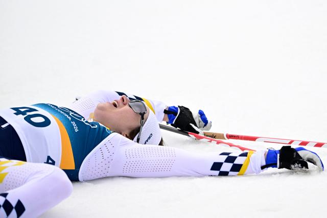 Sweden's Ebba Andersson reacts after crossing the finish line during the women's cross-country skiing 10km interval start free event of the Milano Cortina 2026 Winter Olympic Games at Tesero Cross-Country Skiing Stadium in Lago di Tesero (Val di Fiemme), on February 12, 2026. (Photo by Tobias SCHWARZ / AFP)