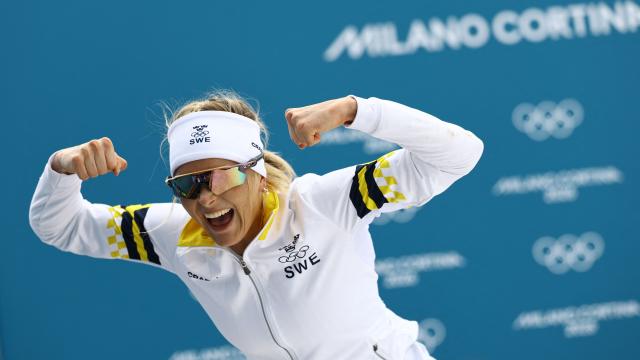 TOPSHOT - Sweden's Frida Karlsson celebrates as the race is not over yet, during the women's cross-country skiing 10km interval start free event of the Milano Cortina 2026 Winter Olympic Games at Tesero Cross-Country Skiing Stadium in Lago di Tesero (Val di Fiemme), on February 12, 2026. (Photo by Anne-Christine POUJOULAT / AFP)