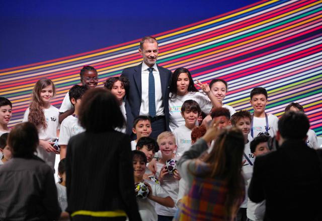 UEFA president Aleksander Ceferin interacts with children ahead of addressing a press conference at the 50th UEFA Ordinary Congress in Brussels on February 12, 2026. (Photo by Pau BARRENA / AFP)