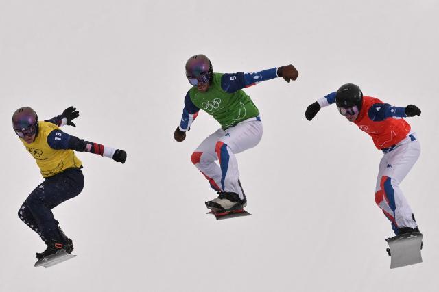 (L-R) USA's Nathan Pare, France's Loan Bozzolo and France's Jonas Chollet compete in the snowboard men's cross quarter final 2 during the Milano Cortina 2026 Winter Olympic Games at Livigno Snow Park, in Livigno (Valtellina), on February 12, 2026. (Photo by Jeff PACHOUD / AFP)