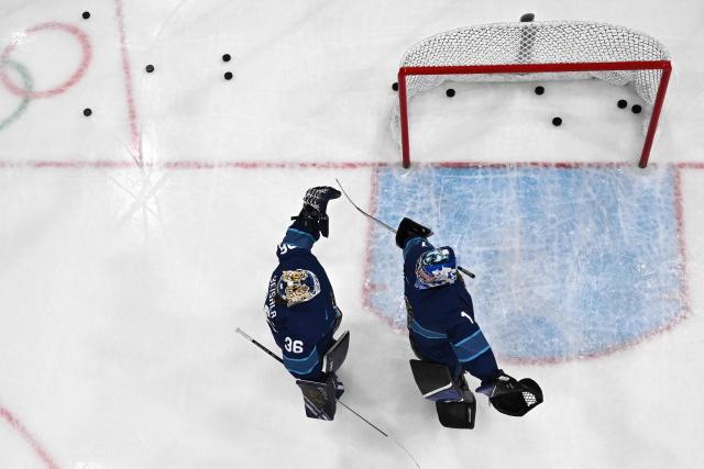 Finland's #36 Anni Keisala and Finland's #01 Sanni Ahola cheer eachother before the women's preliminary round Group A Ice Hockey match between Finland and Canada at the Milano Rho Ice Hockey Arena during the Milano Cortina 2026 Winter Olympic Games in Milan, on February 12, 2026. (Photo by Piero CRUCIATTI / AFP)