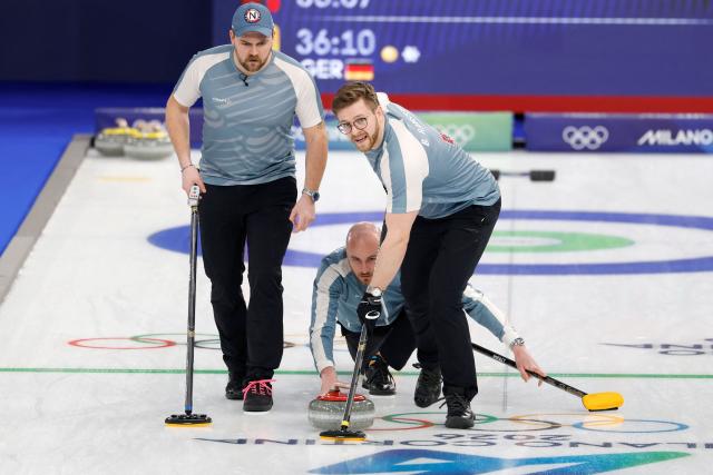 Norway's Bendik Ramsfjell (R) and Norway's Martin Sesaker (L) sweep the ice as Norway's Magnus Ramsfjell (C) watches the stone during the curling men's round robin between Norway and Germany during the Milano Cortina 2026 Winter Olympic Games at the Cortina Curling Olympic Stadium in Cortina d’Ampezzo on February 12, 2026. (Photo by Odd ANDERSEN / AFP)