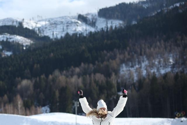 Bronze medallist USA's Jessie Diggins celebrates on the podium for the women's cross-country skiing 10km interval start free event of the Milano Cortina 2026 Winter Olympic Games at Tesero Cross-Country Skiing Stadium in Lago di Tesero (Val di Fiemme), on February 12, 2026. (Photo by Anne-Christine POUJOULAT / AFP)