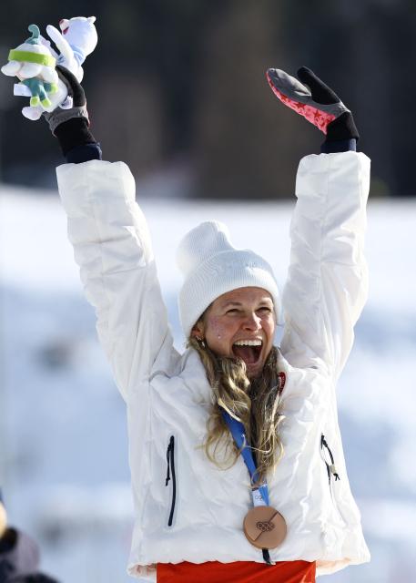 Bronze medallist USA's Jessie Diggins celebrates on the podium for the women's cross-country skiing 10km interval start free event of the Milano Cortina 2026 Winter Olympic Games at Tesero Cross-Country Skiing Stadium in Lago di Tesero (Val di Fiemme), on February 12, 2026. (Photo by Anne-Christine POUJOULAT / AFP)