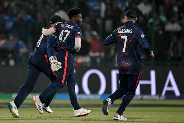 Namibia's Ben Shikongo (C) celebrates with teammates after taking the wicket of India's Sanju Samson during the 2026 ICC Men's T20 Cricket World Cup group stage match between India and Namibia at the Arun Jaitley Stadium in New Delhi on February 12, 2026. (Photo by Arun SANKAR / AFP)