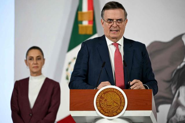 Mexico's Economy Minister Marcelo Ebrard (R) speaks during President Claudia Sheinbaum's (L) daily press conference at Palacio Nacional in Mexico City on February 12, 2026. (Photo by YURI CORTEZ / AFP)