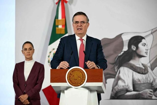 Mexico's Economy Minister Marcelo Ebrard (R) speaks during President Claudia Sheinbaum's (L) daily press conference at Palacio Nacional in Mexico City on February 12, 2026. (Photo by YURI CORTEZ / AFP)